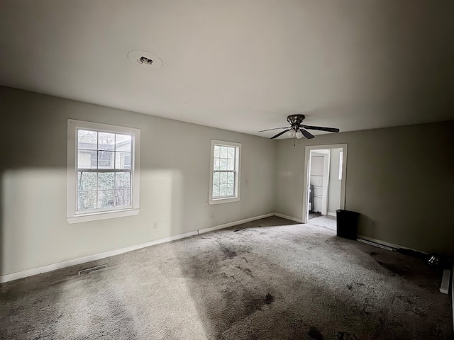 spare room with carpet flooring, plenty of natural light, and ceiling fan