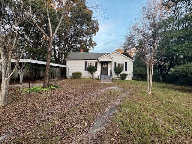 ranch-style home with a front lawn and a carport