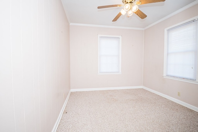 carpeted spare room with ornamental molding, a healthy amount of sunlight, and baseboards