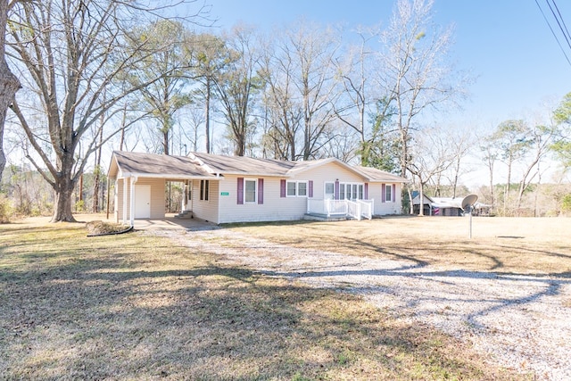 single story home featuring a front lawn and a carport