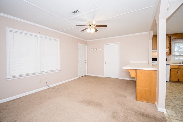 interior space with ornamental molding, visible vents, ceiling fan, and light carpet