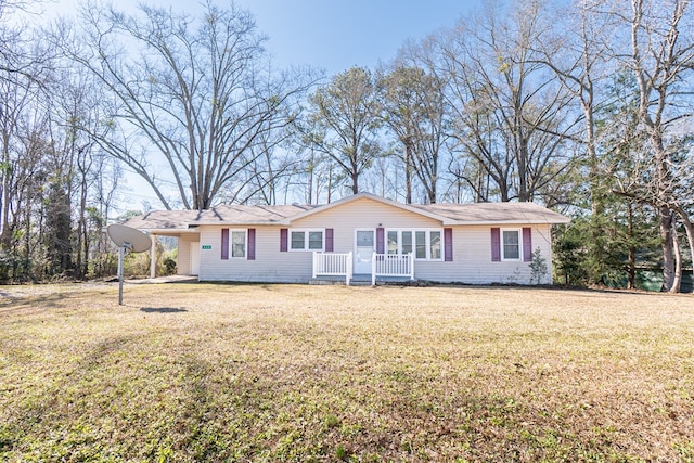 single story home featuring a carport and a front yard