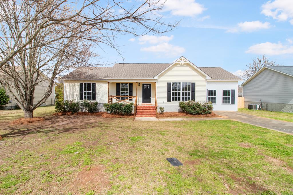 811 Hinton Waters Ave, Midland City, AL 36350 - ranch-style house with a front yard, covered porch, roof with shingles, and central air condition unit