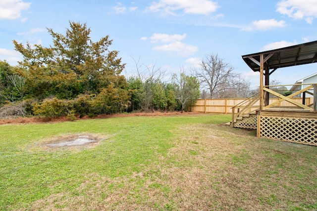 view of yard with a deck and fence