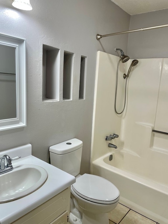 full bathroom featuring toilet, bathtub / shower combination, vanity, and tile patterned flooring