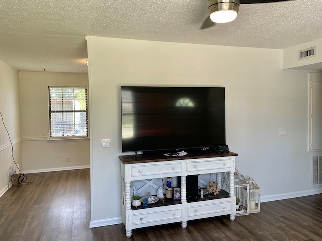 details with visible vents, a textured ceiling, baseboards, and wood finished floors