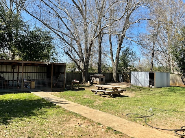 view of yard featuring an outdoor structure and fence