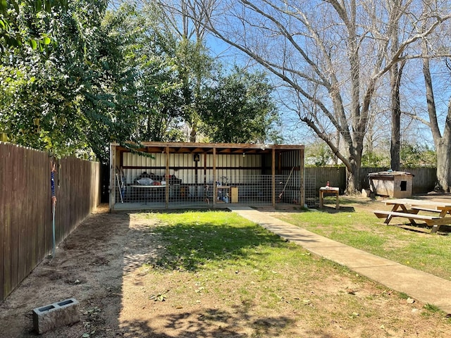 view of yard with a fenced backyard and an outdoor structure