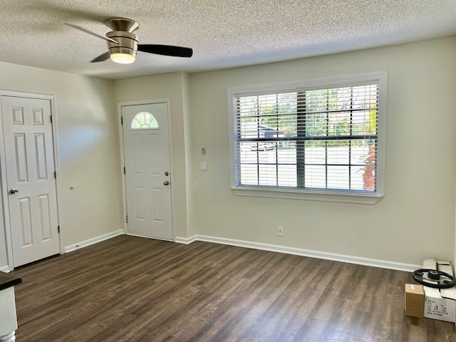 entryway with a ceiling fan, baseboards, dark wood-style flooring, and a textured ceiling