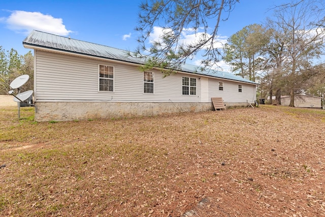 rear view of house with a yard