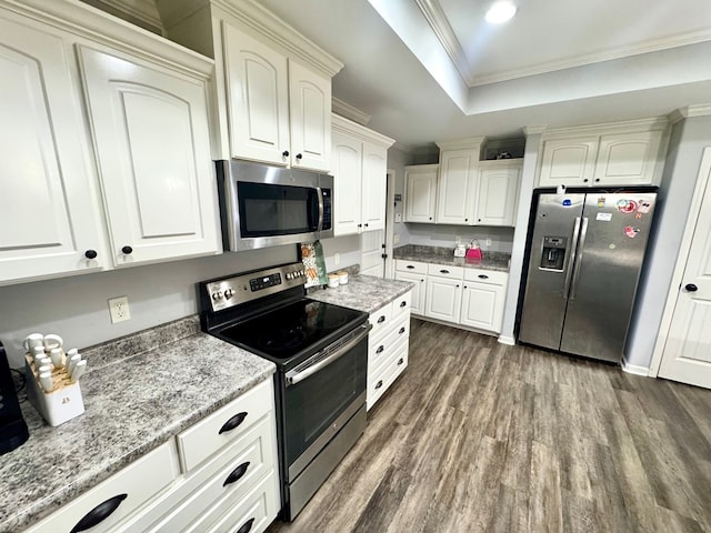 125 Sandpiper Ln, Dothan, AL 36301 - kitchen with appliances with stainless steel finishes, dark wood finished floors, crown molding, light stone counters, and white cabinetry