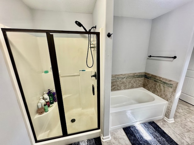125 Sandpiper Ln, Dothan, AL 36301 - bathroom with a shower stall, a garden tub, and a textured ceiling