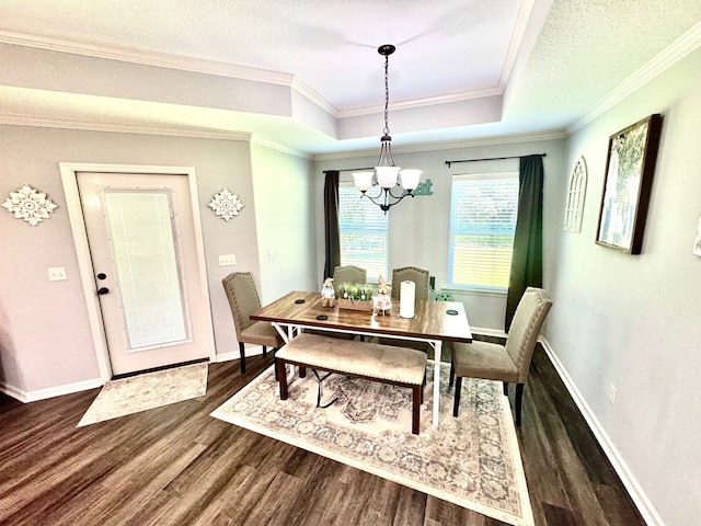 125 Sandpiper Ln, Dothan, AL 36301 - dining area featuring a chandelier, dark wood finished floors, a raised ceiling, and ornamental molding