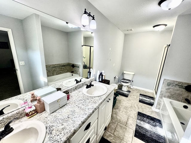 125 Sandpiper Ln, Dothan, AL 36301 - bathroom featuring double vanity, a bath, a stall shower, a textured ceiling, and tile patterned floors