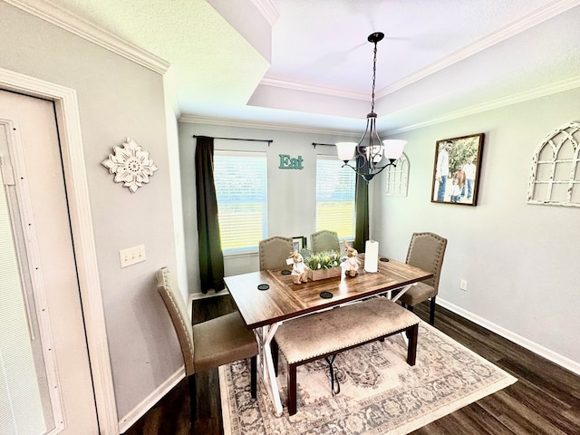 125 Sandpiper Ln, Dothan, AL 36301 - dining room with a chandelier, a tray ceiling, dark wood-style flooring, and ornamental molding