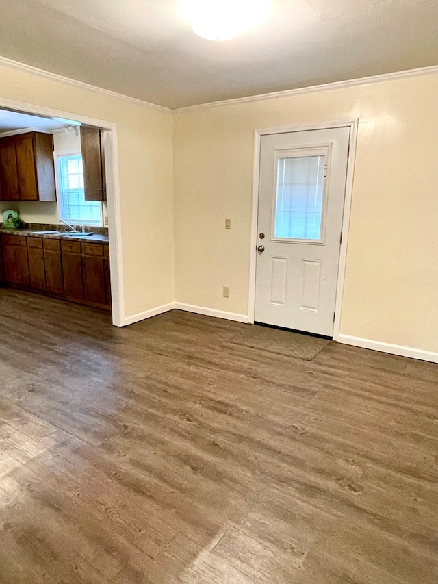 interior space featuring light wood-style floors, baseboards, and ornamental molding