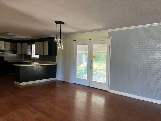 kitchen with sink, a wealth of natural light, ornamental molding, dark hardwood / wood-style flooring, and decorative light fixtures