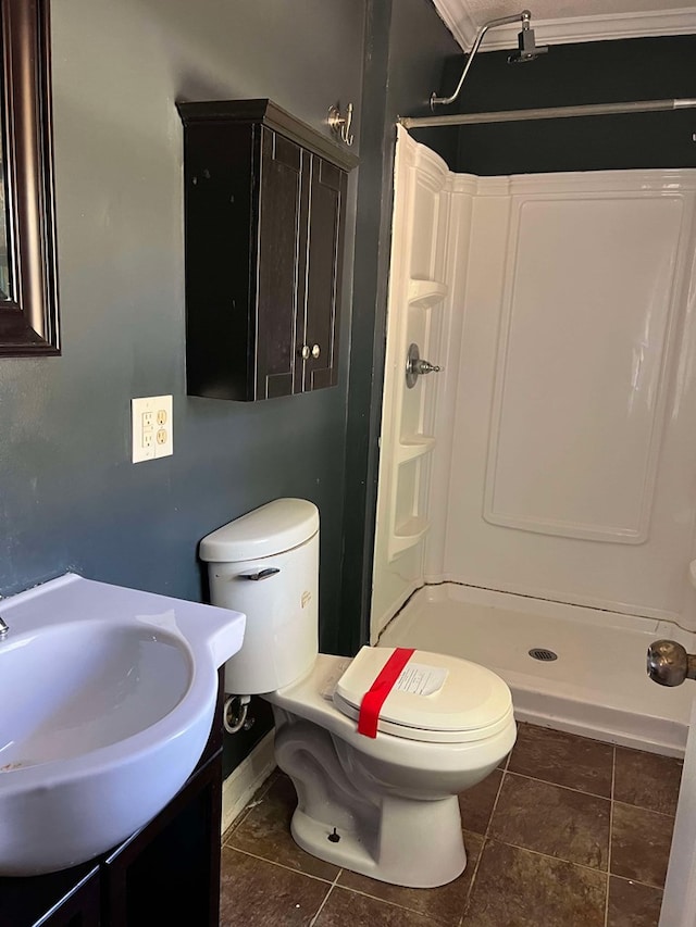 bathroom with walk in shower, vanity, and toilet