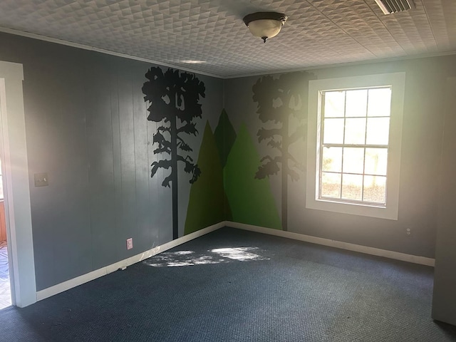 empty room featuring carpet, a healthy amount of sunlight, and ornamental molding