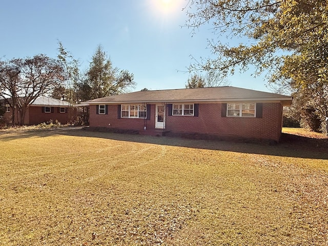 view of front of house with a front yard and brick siding