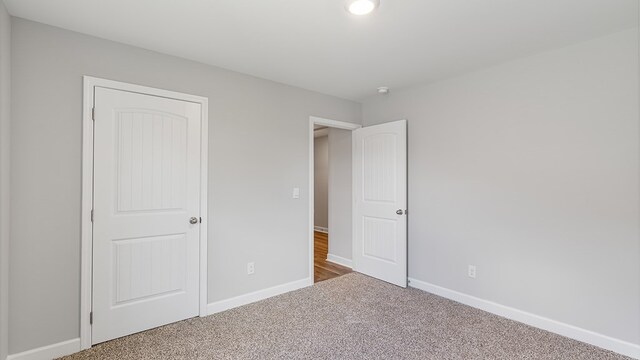 unfurnished bedroom featuring carpet flooring and a closet