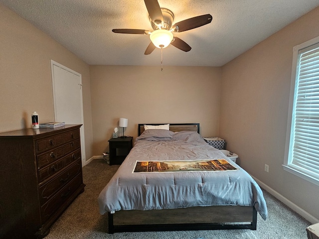 bedroom featuring carpet flooring, a textured ceiling, and baseboards