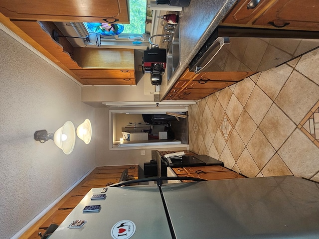 kitchen featuring backsplash and baseboards