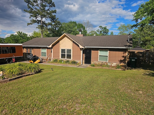 ranch-style house featuring a front yard and stone siding