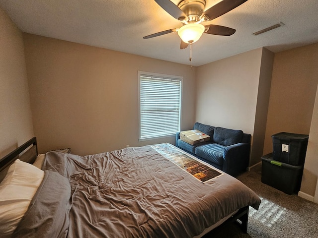 carpeted bedroom with ceiling fan and visible vents