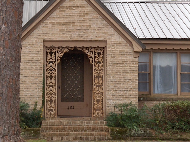 property entrance featuring brick siding