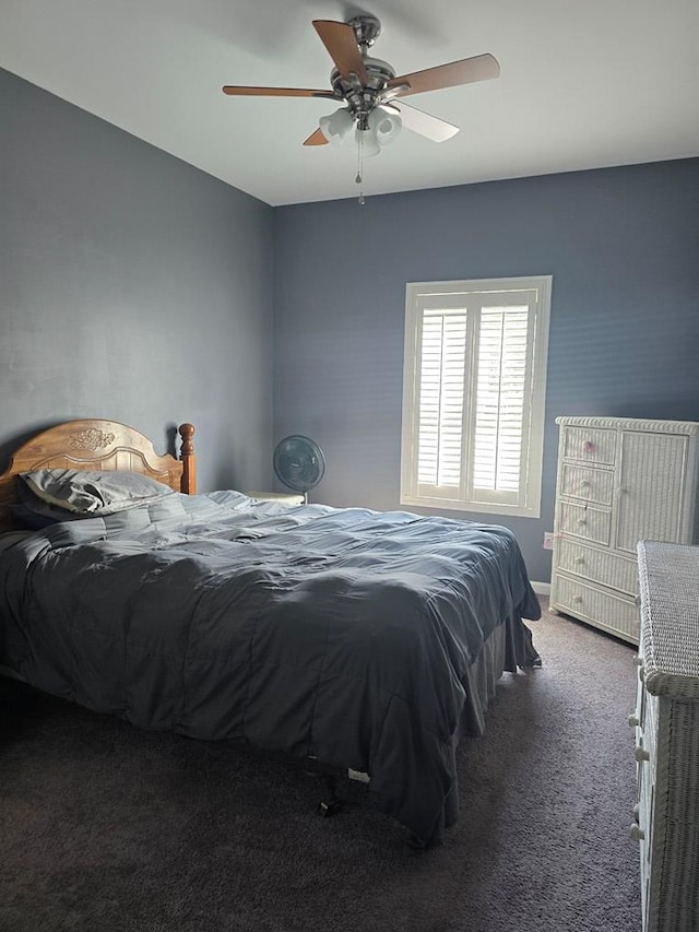 bedroom with dark colored carpet and ceiling fan