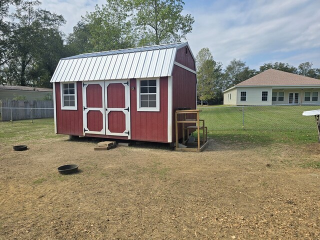 view of outdoor structure featuring a lawn