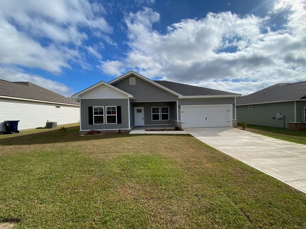 139 Faulk Rd, Dothan, AL 36301 - ranch-style home featuring driveway, board and batten siding, a garage, a front yard, and covered porch