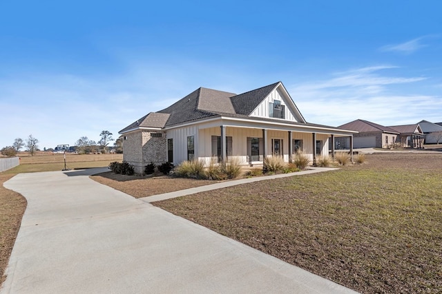 view of front facade with a front lawn and a porch