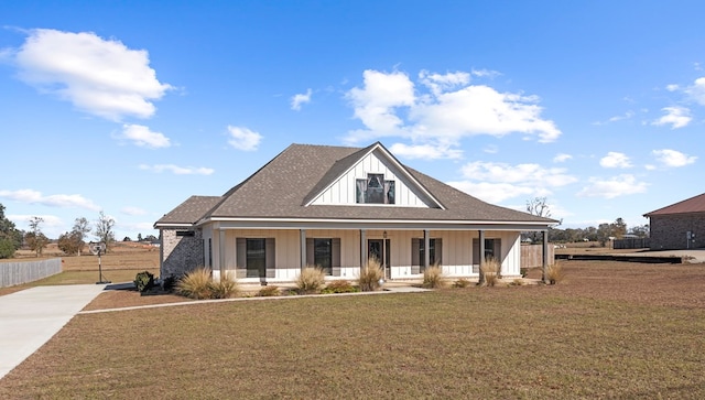 view of front of house featuring a porch and a front lawn