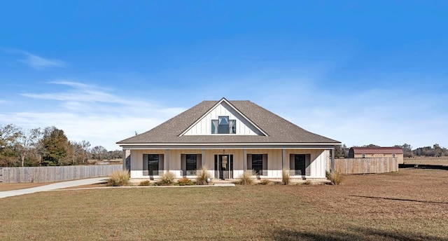 view of front of house featuring covered porch and a front lawn