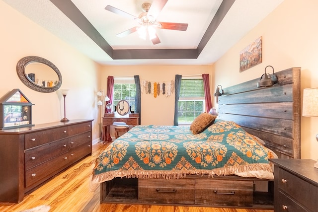 330 Brushfire Dr, Dothan, AL 36305 - bedroom featuring a tray ceiling, wood finished floors, and a ceiling fan