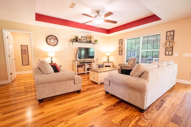 330 Brushfire Dr, Dothan, AL 36305 - living area with a tray ceiling, a ceiling fan, and light wood-style flooring