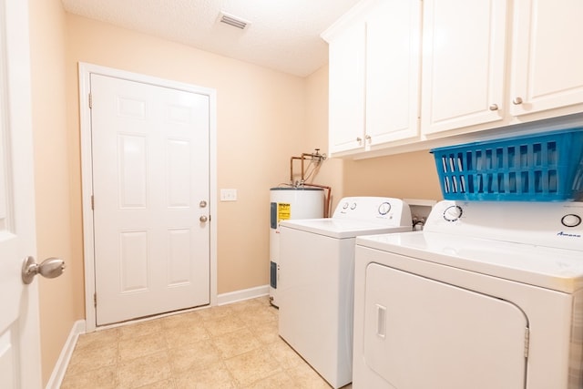 330 Brushfire Dr, Dothan, AL 36305 - laundry room featuring electric water heater, washer and clothes dryer, cabinet space, and a textured ceiling