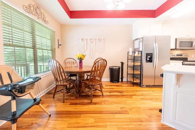 330 Brushfire Dr, Dothan, AL 36305 - dining area with light wood-style flooring and a raised ceiling