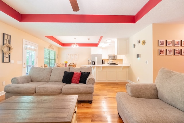 330 Brushfire Dr, Dothan, AL 36305 - living room with a raised ceiling, light wood finished floors, and a ceiling fan