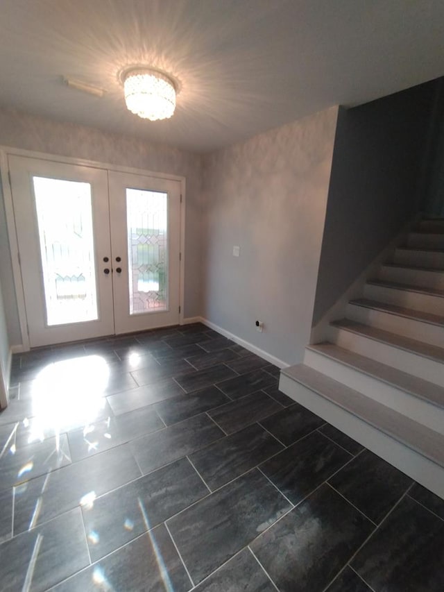 interior space with french doors and a chandelier