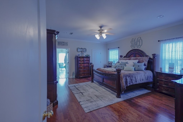 bedroom featuring crown molding, hardwood / wood-style flooring, and ceiling fan