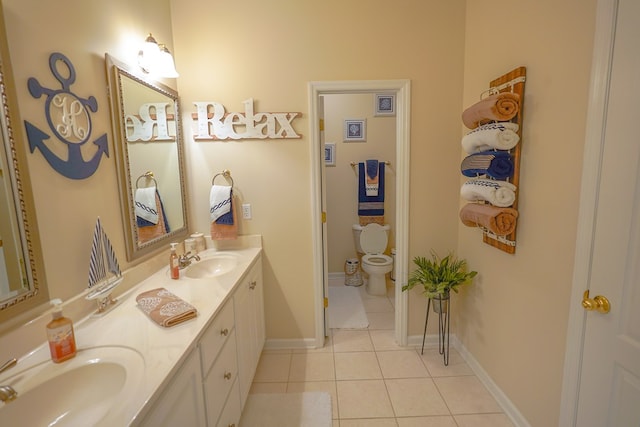 bathroom featuring vanity, tile patterned floors, and toilet