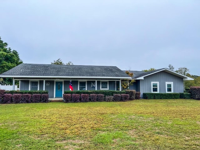 single story home with covered porch and a front yard