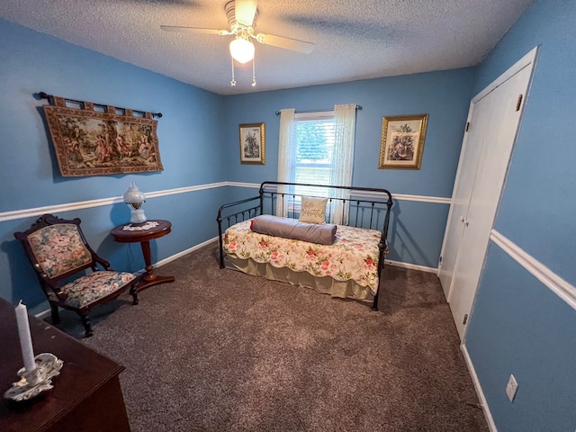 carpeted bedroom with ceiling fan, a textured ceiling, and baseboards