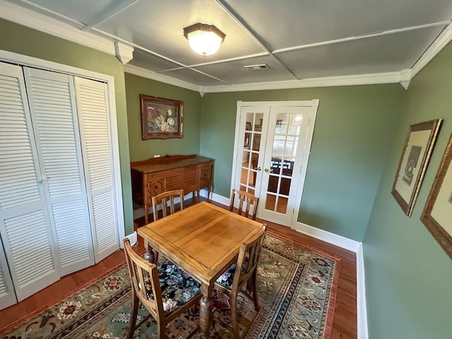 dining space featuring visible vents, ornamental molding, wood finished floors, french doors, and baseboards