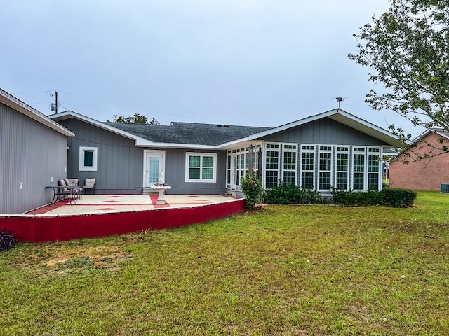 back of property with a patio area and a lawn