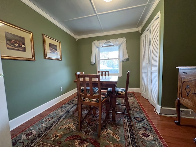 dining area with baseboards, wood finished floors, and crown molding