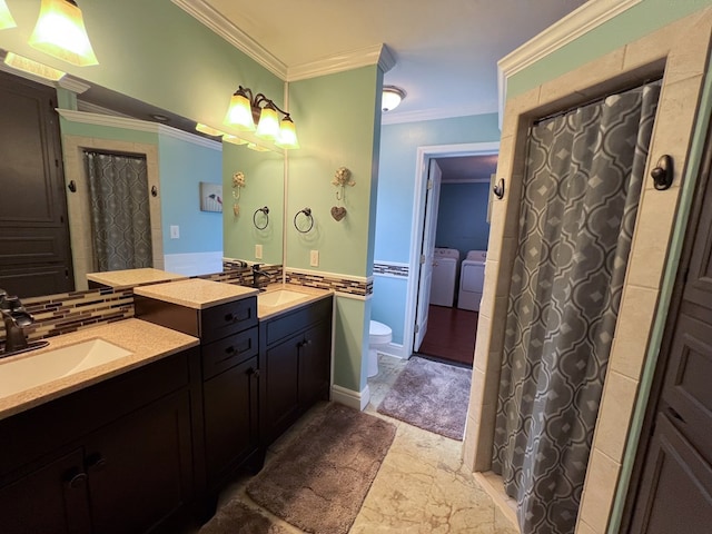 bathroom with backsplash, toilet, ornamental molding, washer and dryer, and vanity